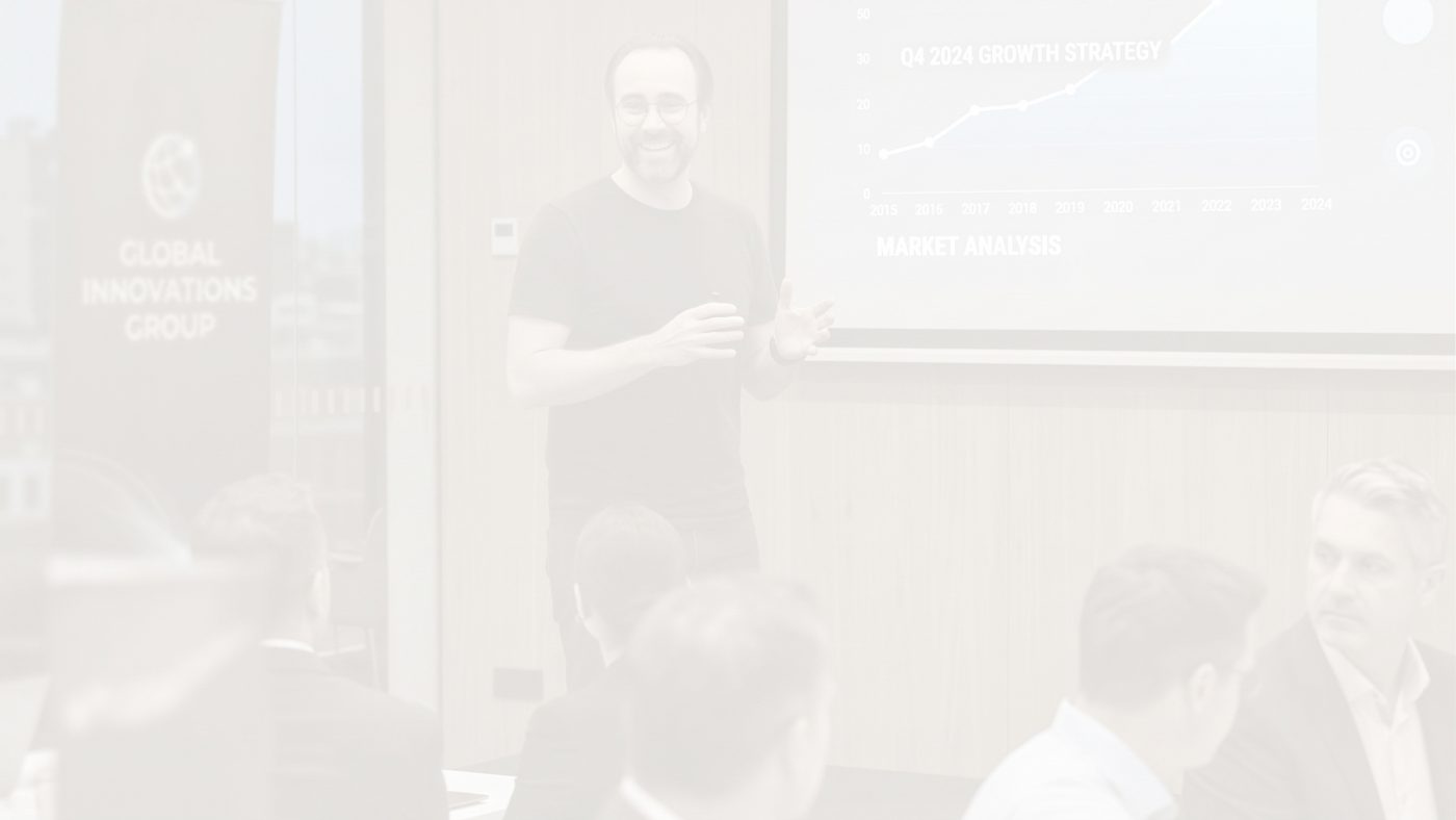 A presenter leading a workshop in front of a room of seated participants